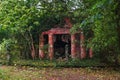 Old Mausoleum with Red Brick Columns Overgrown by Trees and Shrubs, an Ancient German Tomb Without Inscription