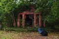 Old Mausoleum with Red Brick Columns Overgrown by Trees and Shrubs, an Ancient German Tomb Without Inscription