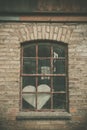 Forgotten love heart in a window Royalty Free Stock Photo