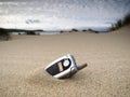 Forgotten mobile phone on the beach