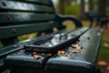 Forgotten smartphone on park bench, a story of a lost connection