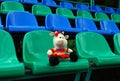 Forgotten by someone in the stands of the stadium dirty soft toy `Cow`. Loneliness.