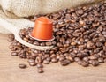 In the forground Wooden spoon and coffee capsule close up Royalty Free Stock Photo