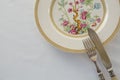 Fork, butter knife, spoon in a plate Royalty Free Stock Photo