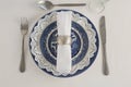 Fork, butter knife, spoon, napkin and lace placemat Royalty Free Stock Photo