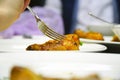 Fork in chicken leg on blurred background Royalty Free Stock Photo