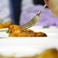 Fork in chicken leg on blurred background Royalty Free Stock Photo