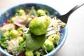 Fork with delicious Brussels sprouts salad over table