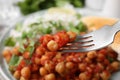 Fork with delicious chickpea curry, closeup view