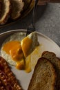 Fork Dividing a fried Egg in a Flavorful Dish