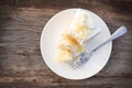 Fork with eaten vanilla sponge cake with buttercream and white c Royalty Free Stock Photo