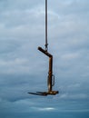 Fork of forklift hanging on crane chain