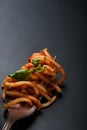 Fork full of twirled italian spaghetti with a bolognese meat sauce and basil. Royalty Free Stock Photo