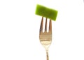 Fork with a green bean slice isolated on white Royalty Free Stock Photo