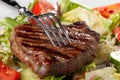 Fork on a grilled steak