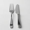 The fork has four tines and a curved handle, while the knife has a Royalty Free Stock Photo