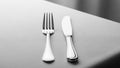 The fork has four tines and the knife features a straight edge Royalty Free Stock Photo