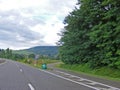 Fork junction sign with crossroads spliting in two way. Roads, view from car