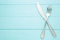 Fork and knife with copy space on a blue wooden background Royalty Free Stock Photo