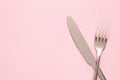 Fork and knife with copy space on a pink background Royalty Free Stock Photo