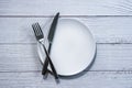 Fork and knife on an empty plate Royalty Free Stock Photo