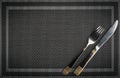 Fork and Knife with golden elements on a placemat Royalty Free Stock Photo