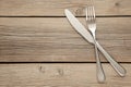 Fork and knife with copy space on a grey wooden background Royalty Free Stock Photo