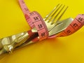 Fork knife measuring tape  colored background Royalty Free Stock Photo