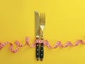 Fork knife measuring tape colored background overeating Royalty Free Stock Photo