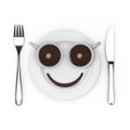 Fork and Knife near Plate with Two Cups of Coffee and Chocolate Smile, in Shape of Cartoon Face, Top View. 3d Rendering Royalty Free Stock Photo