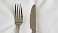 The fork has four tines and the knife has a smooth slightly curved blade Royalty Free Stock Photo