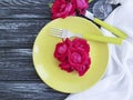 Fork, knife, plate rose flower celebrate dinner on wooden background Royalty Free Stock Photo