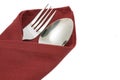 Fork and knife on red napkin isolated Royalty Free Stock Photo