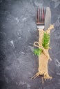 Fork with a knife in the sacking on a gray background Royalty Free Stock Photo