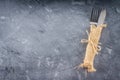 Fork with a knife in the sacking on a gray background Royalty Free Stock Photo
