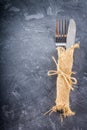 Fork with a knife in the sacking on a gray background Royalty Free Stock Photo