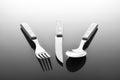 Fork knife and spoon on glossy table surface Royalty Free Stock Photo