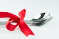 Fork, knife and spoon tied up with red ribbon Royalty Free Stock Photo