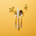 a fork knife and spoon on a yellow background Royalty Free Stock Photo