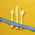 Fork knife spoon on yellow fabric background Royalty Free Stock Photo