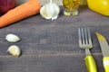 Fork and knife on the table, with vegetables, spices, olive oil and sauce, ketchup. Table ready to eat. carrots, garlic Royalty Free Stock Photo