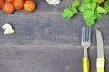 Fork and knife on the table, with vegetables, spices, olive oil and sauce, ketchup. Table ready to eat. carrots, garlic Royalty Free Stock Photo