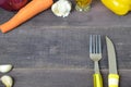 Fork and knife on the table, with vegetables, spices, olive oil and sauce, ketchup. Table ready to eat. carrots, garlic Royalty Free Stock Photo
