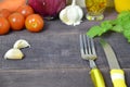 Fork and knife on the table, with vegetables, spices, olive oil and sauce, ketchup. Table ready to eat. carrots, garlic Royalty Free Stock Photo