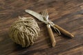 Fork, knife and thread on a wooden table Royalty Free Stock Photo