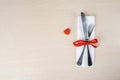 Fork and knife on a tissue near orange knick knack