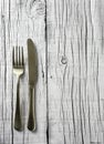 Fork and knife on a white rustic wooden table Royalty Free Stock Photo