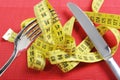 Fork in measure tape in diet and overweight concept Royalty Free Stock Photo