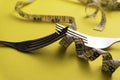 Fork with a measuring tape, diet or healthy eating concept Royalty Free Stock Photo