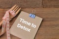 Fork, measuring tape and memo note written with TIME TO DETOX Royalty Free Stock Photo